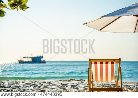Beautiful View From The Tropical Beach To The Ocean, Chaise Longue With Umbrella