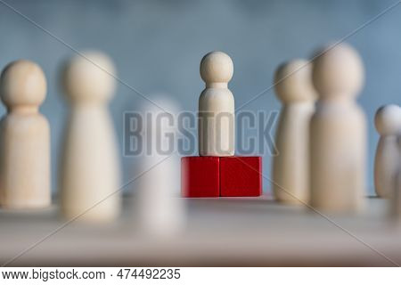 Wooden Figures And Peg Dolls Standing On The Red Podium 1st Positions Of Wooden Cube Blocks. Ranking
