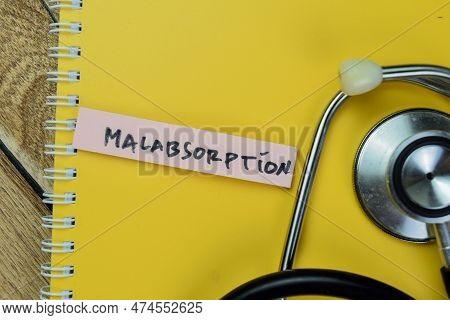 Concept Of Malabsorption Write On Sticky Notes With Stethoscope Isolated On Wooden Table.