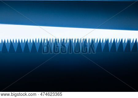 White Sharp Triangles Protrude From The White Body On A Dark Blue Background, Similar To Shark Teeth