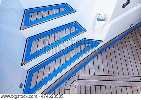 Teak Stairs Descending On A Luxury Yacht. The Texture Of The Teak Deck On The Yacht, Close-up. Teak 