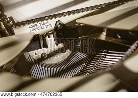 Long-form Journalism Typed Words On A Vintage Typewriter. Close Up Shot Of Simple Message.