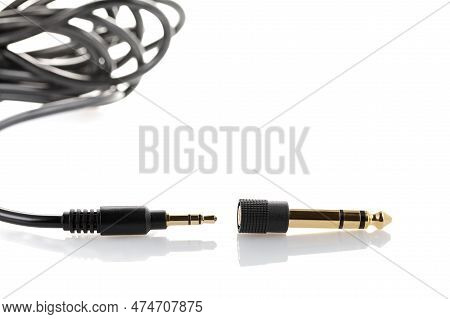 Aux To Mini Jack Adapter. Adapter 3.5 Mm To 6.5 Mm Aux Audio Jack On A White Background. Close Up
