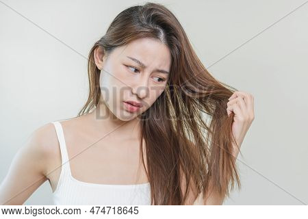 Damaged Hair, Frustrated Asian Young Woman, Girl Hand In Holding Splitting Ends, Messy Unbrushed Dry