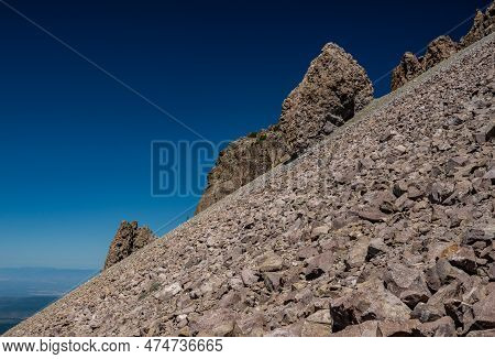 Boulder Jut To Blue Sky Along Steep Slope Of Lassen Peak In Lassen Volcanic National Park