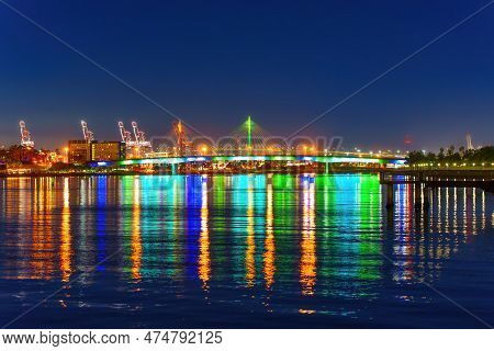 Queensway Bridge In Long Beach, California, Shines Brightly At Night, Casting Reflections In The Wat