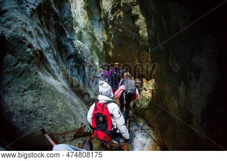 March 22 2022 - Carpathian Mountains Romania Predeal Area, Tourists Assisted By A Guide Climb The Mo