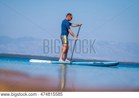Man Riding Sup Stand Up Paddle On Vacation.