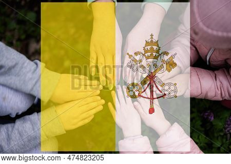 Hands Of Kids On Background Of Vatican City Flag. Vaticanian Patriotism And Unity Concept.