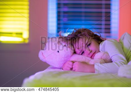 Cute Drowsy Sleepy Child With Toy Teddy Bear In Bed, Bedtime, Childhood And Growth Kids Concept, Clo