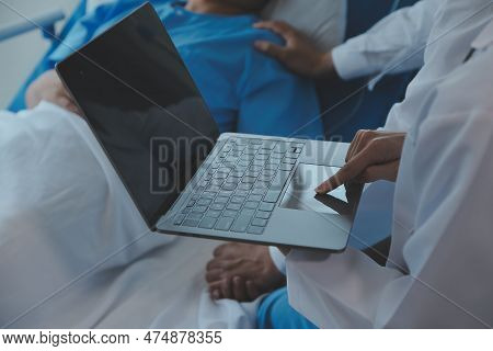 Injured Patient Showing Doctor Broken Wrist And Arm With Bandage In Hospital Office Or Emergency Roo