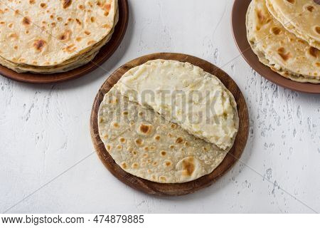 Lean Flatbread Stuffed With Potatoes On A Wooden Board, Light Gray Background, Top View. Cooking Hom