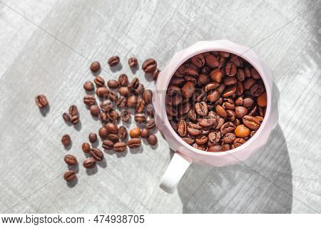 Coffee Beans In Cup On The Table And Coffee Beans Around Cup
