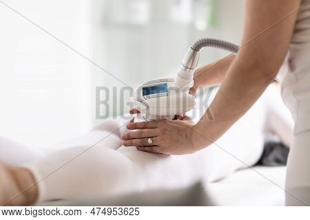 Cosmetics Beautician Holds Lpg Endermology Device On Body Of A Client Lying On A Cosmetics Studio Ta