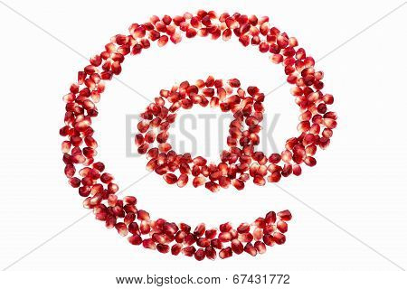 At symbol made from pomegranate seeds