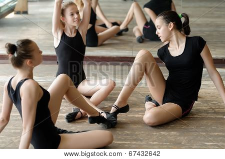 Three ballet dancers on the floor