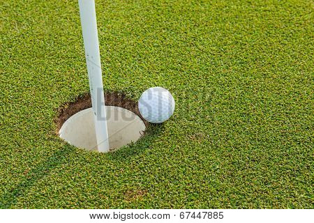 Golf Ball Near The Hole