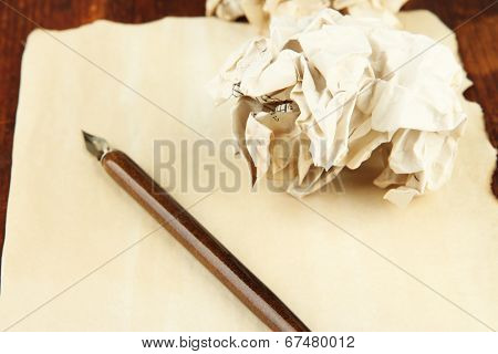 Crumpled paper ball with ink pen on table close up