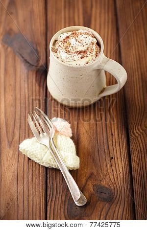 grated chocolate with hot chocolat vintage mug, topping with cream , shallow dof
