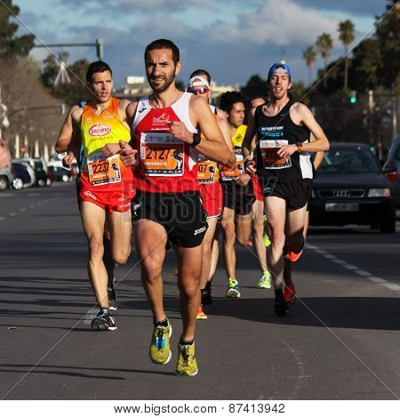 VALENCIA, SPAIN - FEBRUARY 22, 2015: Runners compete in the IV University of Valencia 5K run in the streets of Valencia.