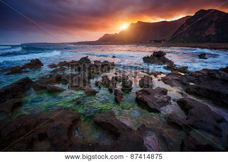 Fantastic view of the nature reserve Dello Zingaro. Dramatic morning scene. Dark overcast sky. Location cape San Vito. Sicilia, Italy, Europe. Mediterranean and Tyrrhenian sea. Beauty world.