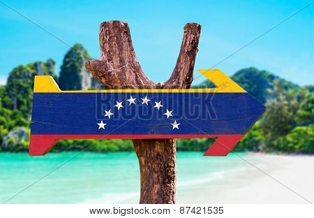 Venezuela Flag wooden sign with beach background