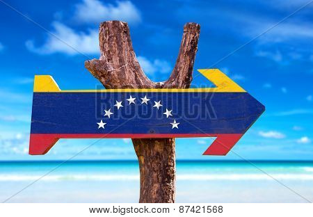 Venezuela Flag wooden sign with beach background