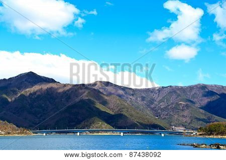 Bridge Of Lake Kawaguchiko With The Background Of Mountain And Blue Sky