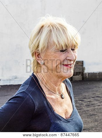 Happy Attractive Senior Woman In Landscape