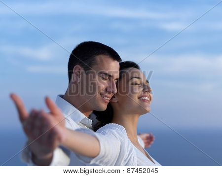 happy young romantic couple have fun relax smile at modern home outdoor terace balcony terace