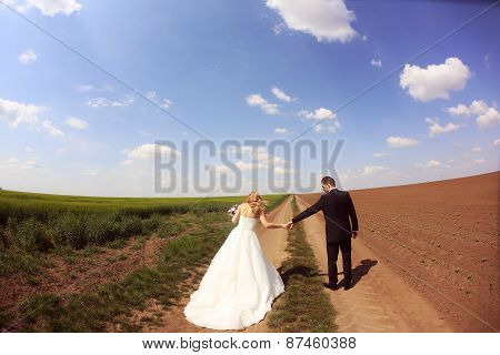 Bride And Groom Having Fun On The Fields