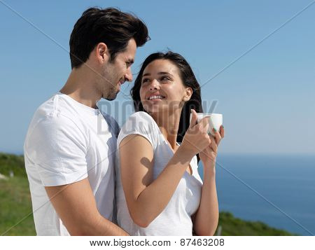 happy young romantic couple have fun relax smile at modern home outdoor terace balcony terace