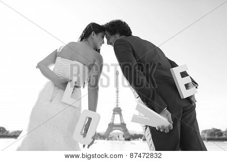 Bride And Groom Holding Love Letters In Their Hand In Paris, France