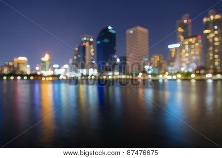 Night city blur bokeh with water reflection