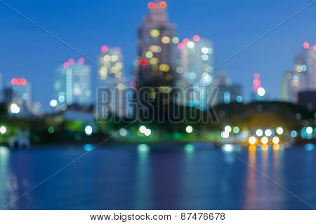 City light blur bokeh, defocused background, with water reflection