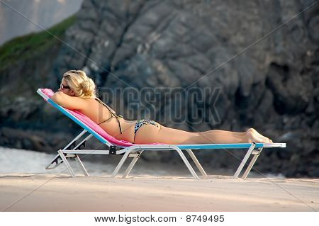 Female Blond model getting a Sun tan