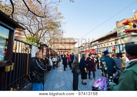 Tokyo, Japan - November 21, 2013: Tourists Shopping At Nakamise Shopping Street In Asakusa