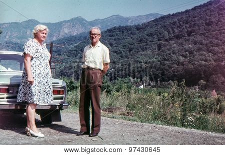 Vintage photo of couple on tar road (early 1970's)