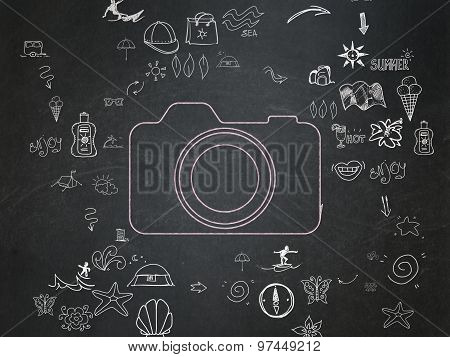 Travel concept: Photo Camera on School Board background