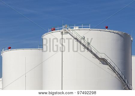 White Tanks In Tank Farm With Iron Staircase