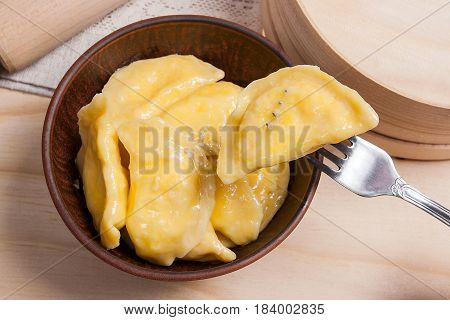 Close Up View Of Boiled Varenyky Or Dumpling With Cottage Cheese Or Curd On Metal Fork. Fresh Boiled