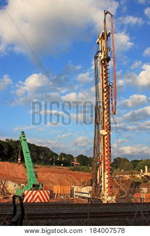 mobile drill and crane on a road construction site