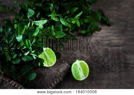Ingredients for mojito. Fresh mint limes sugar over wooden background