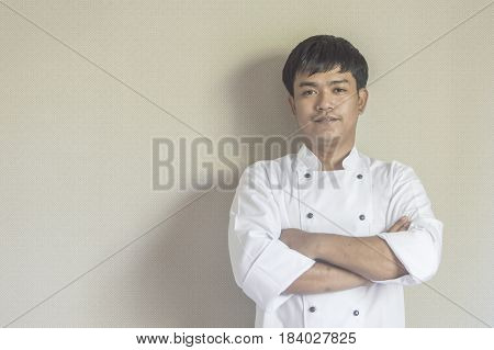Chef portrait Asian young chef crossing arms.