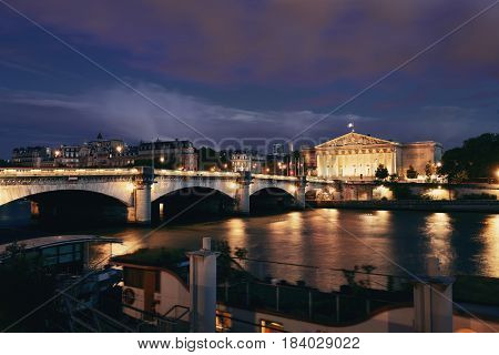 Paris River Seine with Pont de la Concorde and Assemblee Nationale at dusk