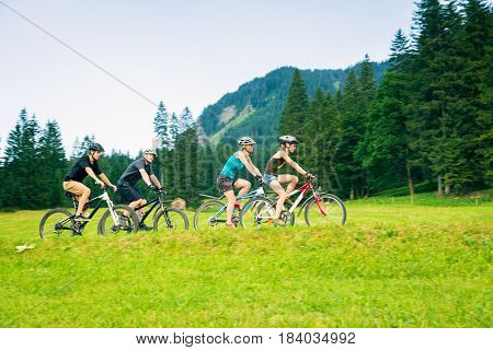 family of four cycling by the vilsalpsee in austria