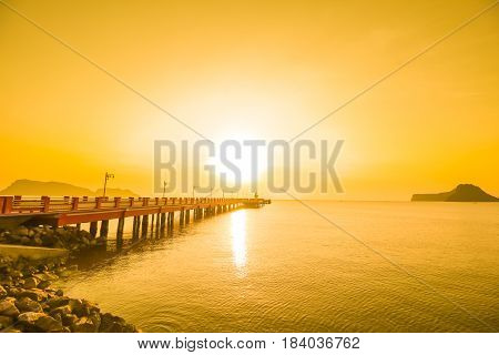 Sunrise over the sea with bridge and lighthouse at prachuapkhirikhanThailand