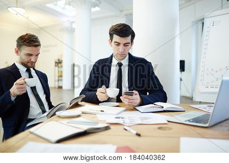 Moderm businessmen having tea and rest at break