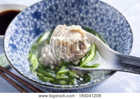 Traditional Chinese Wan Tan Soup as close-up in a bowl