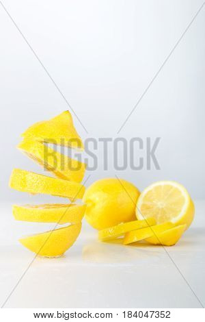 Flying Lemon. Sliced Lemon On White Background. Levity Fruit Floating In The Air.